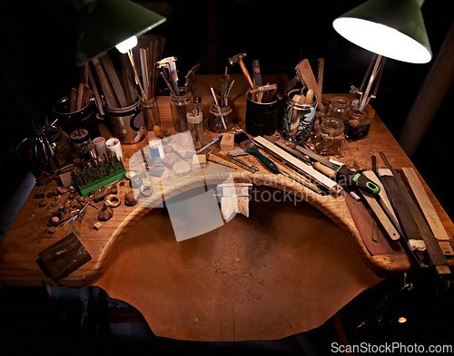 Image of Woodworking, tools and table in workshop for artist in sculpture to start project at night. Dark, studio and creative workspace for carpenter with equipment on desk for process and production