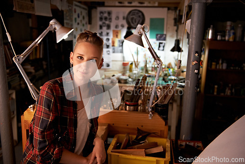 Image of Artist, studio and portrait of woman in workshop for creative sculpture or project at night. Artisan, workplace or person with pride or confidence as carpenter with talent for working with tools