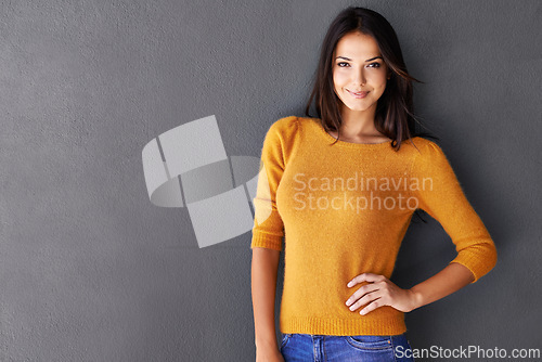 Image of Mockup space, fashion and woman in studio, portrait and cool or trendy style in gray background. Female model, smile and confidence or proud, standing and stylish or edgy in casual outfit or clothes