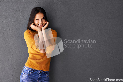 Image of Fashion, female model and hands in portrait or studio, trendy or cool in gray background. Woman, smile and happy with confidence or pride in mockup space, stylish and edgy in casual outfit or clothes