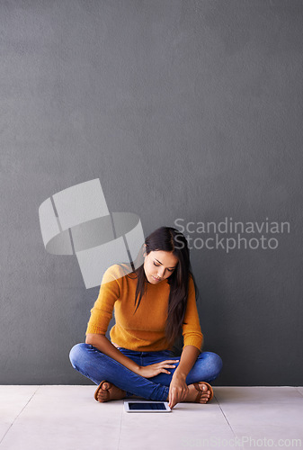 Image of Tablet, search and woman on a floor with social media, scroll or elearning research on wall background space. Digital, mockup or lady student in a house with app for ebook, course or online education