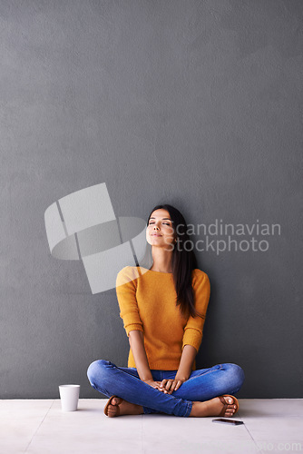 Image of Woman, peace and relax or breathe in home, calm and cup of coffee on floor of living room. Female person, mockup space and wall background for meditation, hot drink and daydreaming in apartment