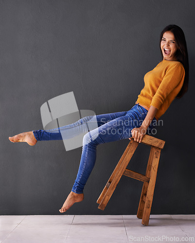 Image of Woman, smile and portrait on chair for clothes, trend and style for fashion and bold color for weekend. Female person, model and happy with jersey for casual outfit, stylish and fashionable on mockup