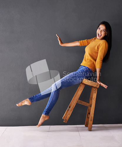 Image of Woman, stool and fashion for style, trendy and portrait for smile and apparel in clothes and excited. Female person, silly and lean on chair for wardrobe, confident and elegant funny and mockup