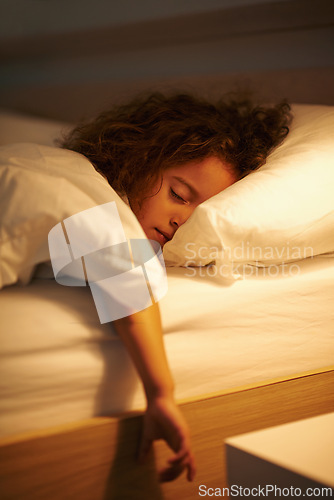 Image of Girl, sleeping and relax in bed at night, comfortable and tired or dream on pillow in home. Female person, child and resting in bedroom or lying for peace, exhausted and fatigue or blanket for calm