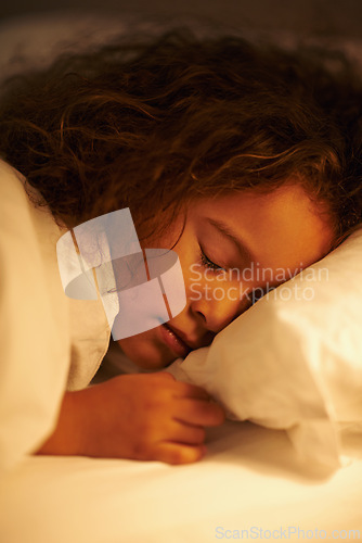 Image of Girl, sleeping and dream in bed at night, comfortable and tired or bedtime on pillow in home. Female person, child and resting in bedroom or lying to relax, exhausted and fatigue or peace in closeup