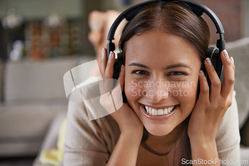 Image of Music, listening and portrait of happy woman on sofa in home streaming radio, playlist or podcast. Girl, smile and hearing sound from headphones on couch with free audio or relax with rock song