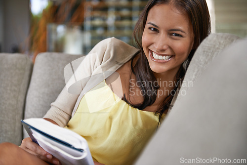 Image of Happy, portrait and woman reading book on couch and relax on holiday or vacation in home with fantasy novel. Calm, break and learning about history or philosophy on comfortable sofa in apartment