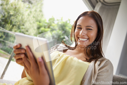 Image of Happy, woman and reading with tablet on sofa in home with social media, online shopping or scroll website. Streaming, ebook or girl relax on couch with video or search internet for news information