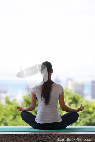 Image of Woman, meditation and yoga with mat by window for workout, exercise or spiritual wellness at home. Rear view of female person or yogi meditating in relax for inner peace, zen or fitness at the house