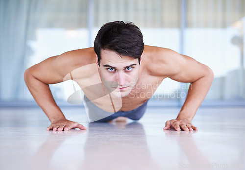 Image of Man, portrait and push up for fitness, muscle training with body and self care in apartment. Serious athlete, exercise and endurance in workout for health, wellness for sports and challenge at home