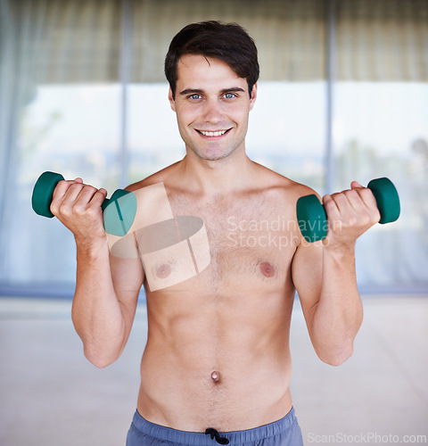 Image of Happy man, portrait and dumbbells for weightlifting, fitness and muscle training for body and self care. Topless athlete, exercise and endurance in workout at home for health, wellness and strength