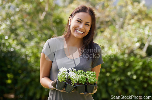 Image of Portrait, smile and excited woman in a garden with plant, sprout or leaf growth outdoor. Backyard, sustainability and face of female person gardening outside for lawn, grass or asylum seedling soil