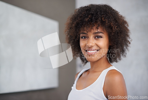 Image of African woman, portrait and happy in bathroom for beauty, wellness and afro in home to start morning routine. Girl, person and happy with cosmetics, change and transformation with hair in apartment