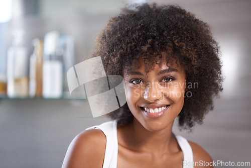 Image of African woman, portrait and smile in bathroom for beauty, wellness and afro in home to start morning routine. Girl, person and happy with cosmetics, change and transformation with hair in apartment