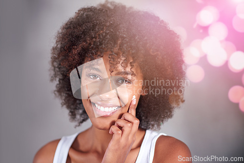 Image of African woman, portrait and skin cream with smile, wellness and afro in home bathroom to start morning routine. Girl, person and serum with cosmetics, bokeh or transformation with beauty in apartment