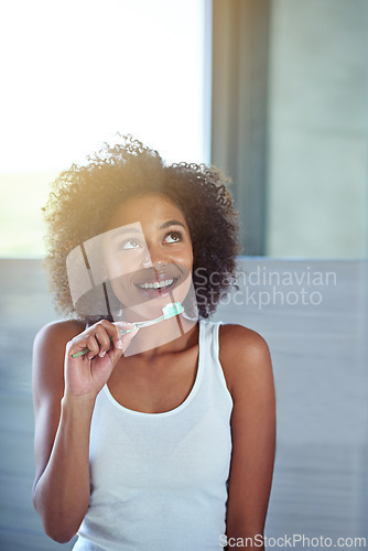 Image of African woman, toothbrush and happy in bathroom for oral wellness, health and benefits for mouth in home. Girl, person and teeth whitening with thinking, cleaning and toothpaste for results in house