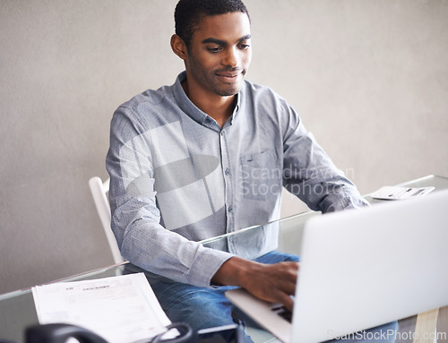 Image of Home office, typing and black man on laptop for business, remote work and reading email on internet. Pc, computer and professional freelancer at desk for blog, article or copywriting for creativity