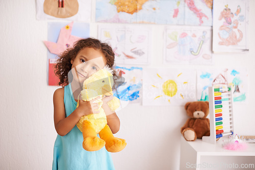 Image of Girl, portrait and cute with duck to cuddle in bedroom for comfort or playtime, smile and innocent. Child, adorable and hug stuffed animal for youth and happiness with bonding embrace for development