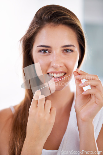 Image of Smile, oral care and portrait of woman with floss for health, wellness and clean routine for hygiene. Dental, happy and female person with dentistry tool for teeth or mouth treatment in bathroom.