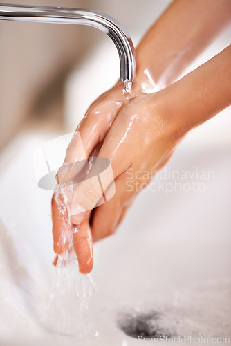 Image of Cleaning, water and soap on hands of person with skincare, routine and grooming in home closeup. Bathroom, tap and washing skin with foam for protection of hygiene from germs, bacteria and virus