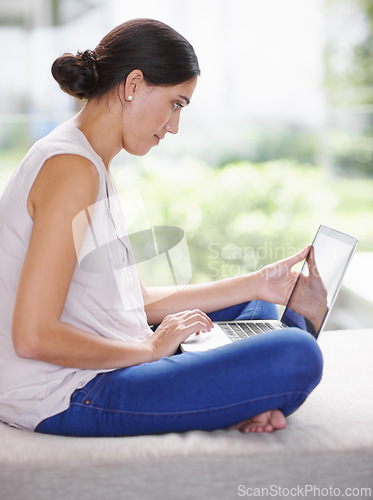 Image of Laptop, relax and woman on sofa working on creative freelance project at modern apartment. Technology, research and young female person reading information on internet with computer in living room.