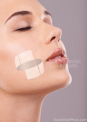 Image of Closeup, woman or glow of makeup for beauty, microblading or cosmetology in spa, facial or treatment. Female person, lip gloss or flawless skin as dermatology or skincare in studio on grey background