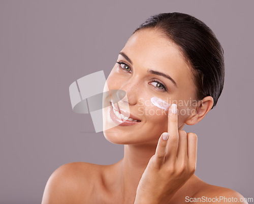 Image of Portrait, cream and woman with skincare, beauty and dermatology on grey studio background. Face, person and model with lotion and shine with wellness and cosmetics with moisturise, glow and aesthetic