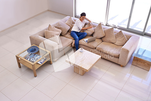 Image of Home, relax and woman on sofa with laptop for remote work, internet search or website subscription. Computer, online streaming and freelance girl on luxury couch checking social media with high angle