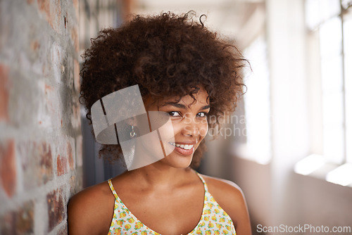 Image of Portrait, happy and woman by brick wall at university for education, learning or confidence in corridor alone. Face, student and young girl in hallway of college for profile picture in South Africa