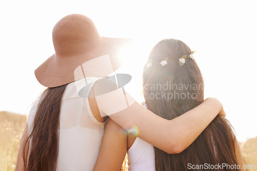 Image of Friends, hug and walking in summer nature on holiday or journey on vacation for adventure. Women, back and embrace outdoor together in sunshine on field, trekking on hill or travel environment