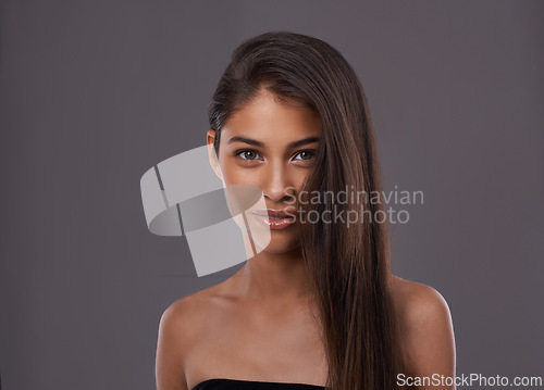 Image of Portrait, hair care and beauty of woman in makeup, glow or shine isolated on gray studio background. Face, hairstyle and Indian model in cosmetics at salon for skincare at hairdresser on mockup space
