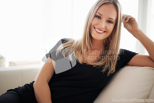 Image of Happy, portrait and woman on a sofa relax with confidence, positive attitude or leisure in her home. Face, smile and female person in a living room with vacation, free time or resting holiday