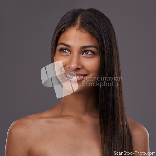 Image of Beauty, hair and face of woman on gray background for healthy texture, wellness and shine. Haircare, hairdresser and happy person with long hairstyle for salon products, cosmetics and glow in studio