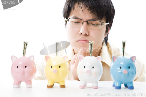 Image of Asian businessman saving money