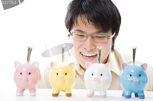 Image of Asian businessman saving money