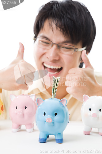 Image of Asian businessman saving money