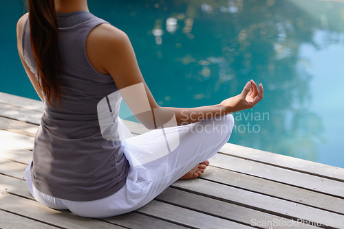 Image of Back, pool and meditation with woman, lotus and fitness with sunshine and yoga with breathing. Rear view, person and water with girl and yogi with wellness and healthy with balance, relax and peace