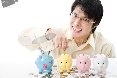 Image of Asian businessman saving money