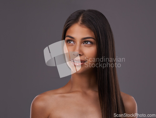 Image of Thinking, hair and face of woman in on gray background for healthy texture, wellness and beauty. Haircare, hairdresser and person with long hairstyle for salon products, cosmetics and shine in studio