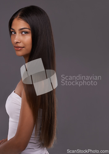 Image of Hair care, portrait and beauty of woman, skincare and mockup space isolated on gray studio background. Hairstyle, face and Indian model in makeup cosmetics at salon for body treatment at hairdresser