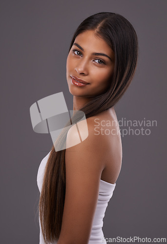 Image of Portrait, hair care and beauty of woman in makeup, glow or shine isolated on gray studio background. Face, hairstyle and Indian model in cosmetics at salon for skincare treatment, hairdresser or body