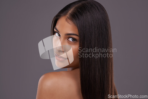 Image of Confident, hair and portrait of woman on gray background for healthy texture, wellness or beauty. Haircare, hairdresser and person with long hairstyle for salon products, cosmetics or shine in studio
