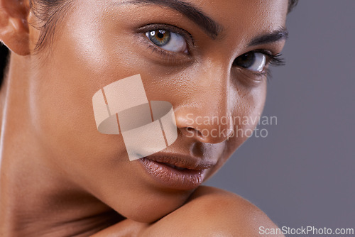 Image of Portrait, skincare and beauty of woman in makeup, glow or shine isolated on gray studio background. Face, serious and Indian model in cosmetics in spa for facial treatment, dermatology and closeup