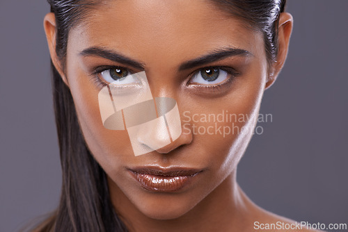 Image of Portrait, skincare and beauty of woman in makeup, glow or shine isolated on gray studio background. Face, serious and Indian model in cosmetics in spa for facial treatment, dermatology or skin health