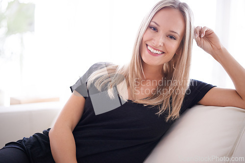 Image of Portrait, happy and woman on a sofa relax with confidence, positive attitude or feel good mood in her home. Face, smile and female person in a living room with vacation, free time or resting holiday