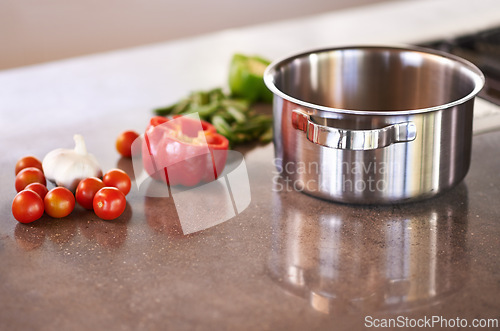 Image of Kitchen counter, pot and vegetable ingredients to cook for healthy, meal and supper for wellbeing, diet and nutrition. Home, natural and fresh with organic food to prepare for dinner and soup