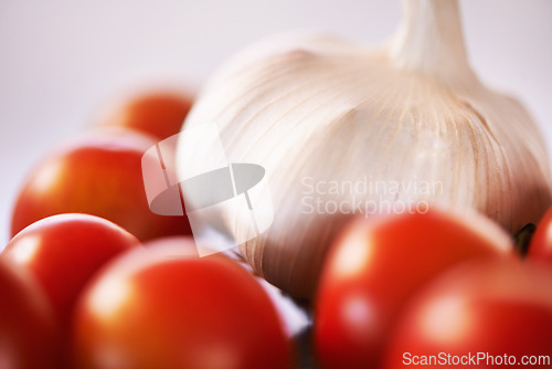 Image of Home, garlic and tomatoes with kitchen counter, ingredients and groceries with recipe and healthy. Wellness, closeup and mockup space with vegetables and nutrition with vegan and organic food