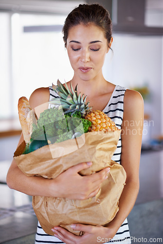 Image of Home, delivery or woman with groceries or food, sale or discounts deal on nutrition in kitchen. Customer, offer or female person buying healthy vegetables for cooking organic fruits or diet choice