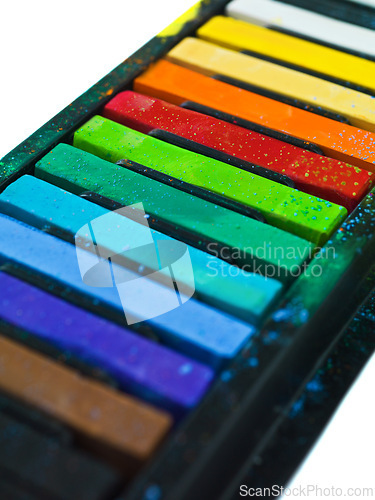 Image of Paint, pastel and artist chalk in studio for rainbow or vibrant creativity, texture and pigments for fine or visual arts. Oil or watercolor sticks, color or palette to shade or blend with composition